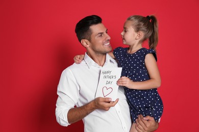 Little girl greeting her dad with Father's Day on red background