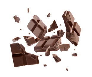 Milk chocolate pieces falling on white background