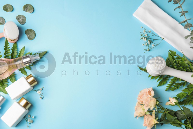Photo of Flat lay composition with face cleansing brushes on light blue background, space for text. Cosmetic accessories