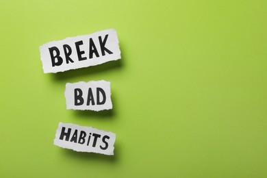 Phrase Break Bad Habits on green background, flat lay. Space for text
