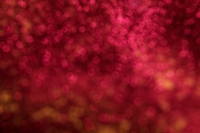 Blurred view of pink glitter as background. Bokeh effect