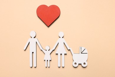 Figures of family and heart on beige background, top view. Insurance concept
