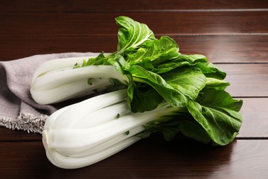 Fresh green pak choy cabbages on wooden table