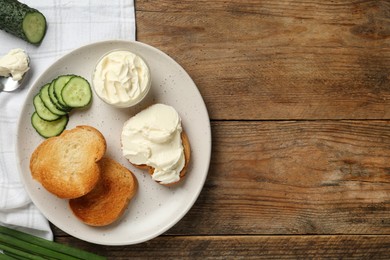 Photo of Delicious sandwich with cream cheese and ingredients on wooden table, flat lay. Space for text