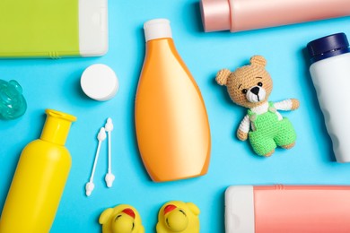 Photo of Flat lay composition with baby cosmetic products on light blue background