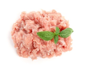 Pile of raw chicken minced meat with basil on white background, top view