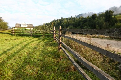 Photo of Beautiful view with wooden fence near road