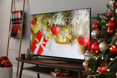 Modern TV and Christmas decor in room