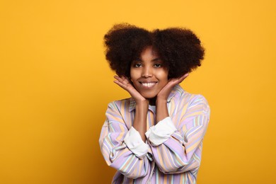 Photo of Portrait of smiling African American woman on orange background