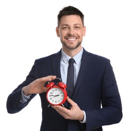 Happy businessman holding alarm clock on white background. Time management