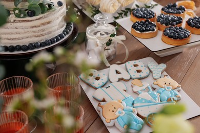 Beautiful cake and other treats on table. Baby shower party