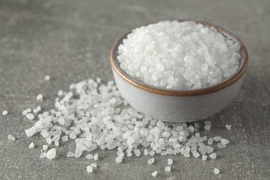 Bowl of natural sea salt on grey table