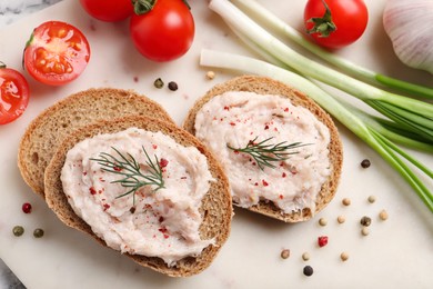 Photo of Sandwiches with delicious lard spread and vegetables on board, flat lay