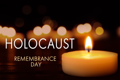 Image of International Holocaust Remembrance Day. Burning candle on black table, closeup