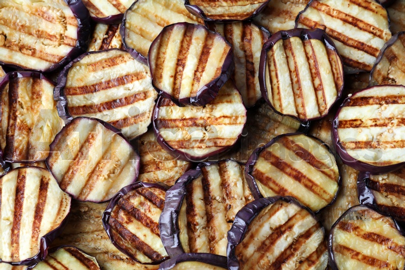 Delicious grilled eggplant slices as background, closeup