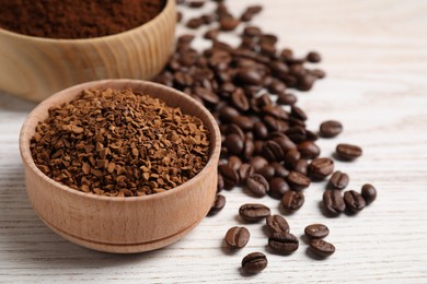 Photo of Different types of coffee on white wooden table, closeup