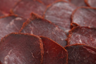 Delicious dry-cured beef basturma slices as background, closeup
