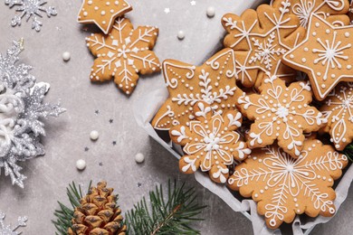 Tasty Christmas cookies and festive decor on light grey table, flat lay