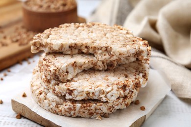 Stack of crunchy buckwheat cakes on wooden table, closeup