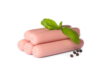 Raw vegetarian sausages with basil on white background