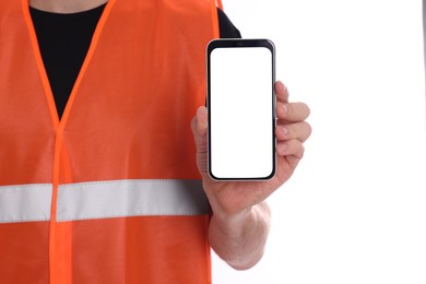 Photo of Male industrial engineer in uniform with phone on white background, closeup