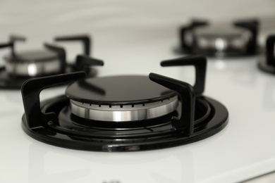 Photo of Modern built-in gas cooktop, closeup. Kitchen appliance