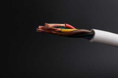 Cable with electrical wires on black background, closeup