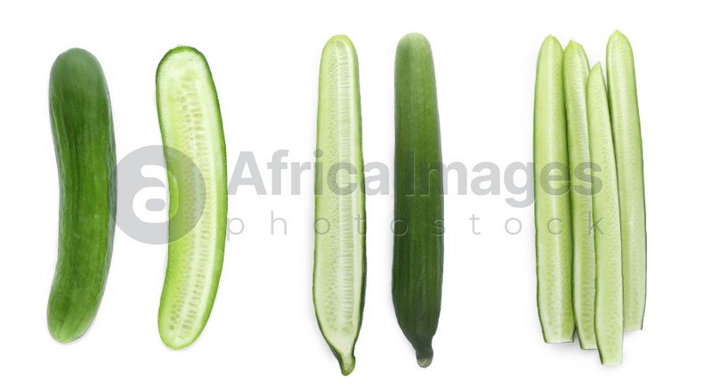 Set with whole and cut ripe cucumbers on white background, top view