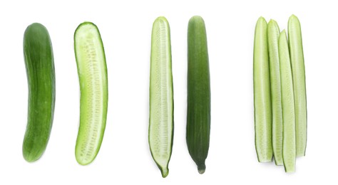 Set with whole and cut ripe cucumbers on white background, top view