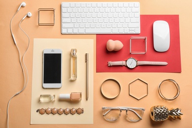 Photo of Blogger's workplace with smartphone and different stuff on color background, flat lay