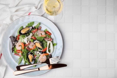 Photo of Plate of delicious salad with seafood on white tiled table, flat lay. Space for text
