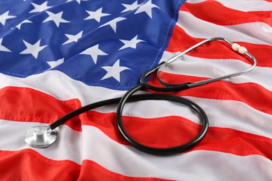 Photo of Stethoscope on American flag. USA medicine and health care concept