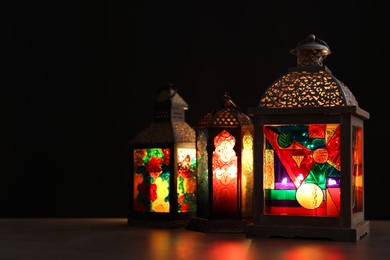 Decorative Arabic lanterns on table against dark background