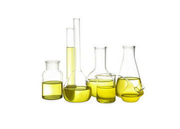 Different laboratory glassware with yellow liquid isolated on white