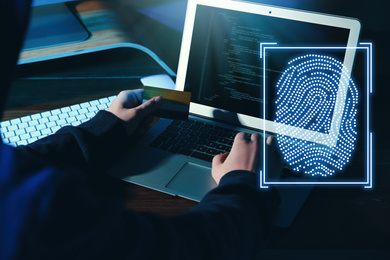 Fingerprint identification. Man working with laptop at table, closeup