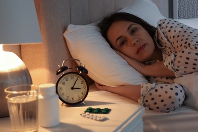 Mature woman suffering from insomnia in bed at night