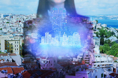 Young woman holding virtual image of city, closeup. Modern technology
