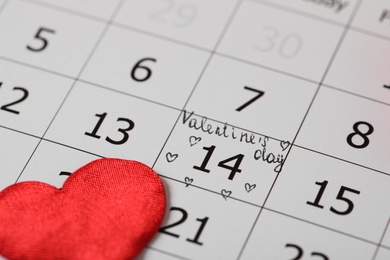 Calendar with marked Valentine's Day and red heart, closeup