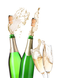Champagne splashing out of bottles and glasses on white background 