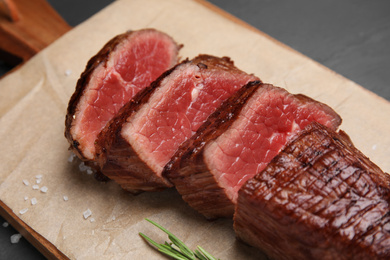 Delicious sliced beef tenderloin on table, closeup