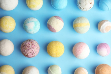 Photo of Flat lay composition with bath bombs on color background