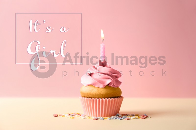 Image of Baby shower cupcake with candle for girl on pink background
