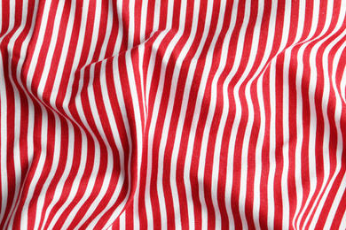 Texture of red striped fabric as background, closeup