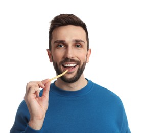 Man eating French fries on white background