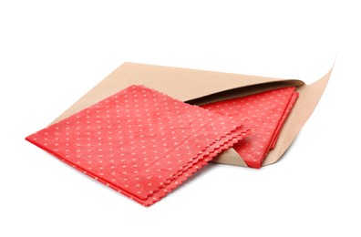 Red reusable beeswax food wraps on white background