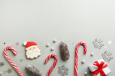 Flat lay composition with candy canes and Christmas decor on grey background. Space for text
