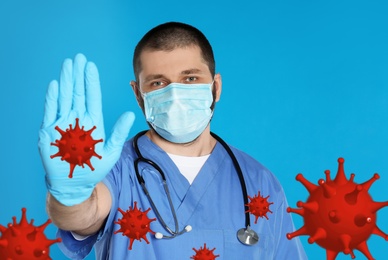 Stop Covid-19 outbreak. Doctor wearing medical mask surrounded by virus on blue background
