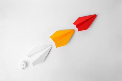 Photo of Idea concept. Paper planes following red one on white background, flat lay