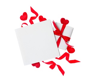 Blank card, gift box and red decorative hearts on white background, top view. Valentine's Day celebration