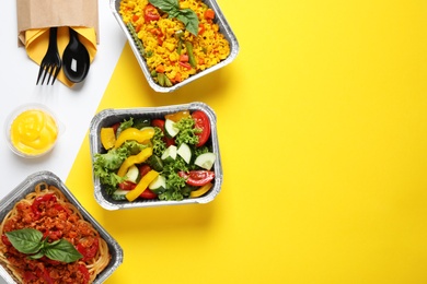 Lunchboxes on color table, flat lay. Healthy food delivery
